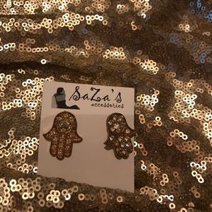 Gold and crystal stone hamsa earrings. Boutique